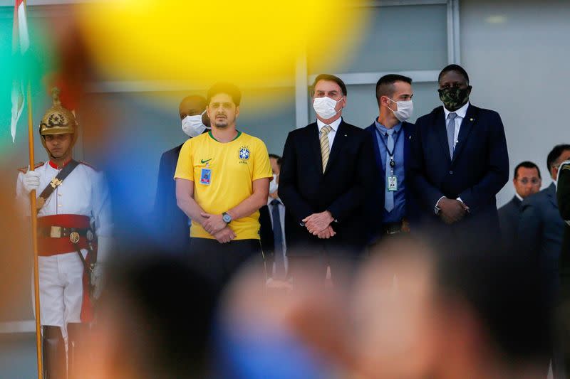 Brazil's President Jair Bolsonaro observes supporters during a demonstration outside Planalto Palace, amid the spread of the coronavirus disease (COVID-19), in Brasilia