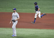 Tampa Bay Rays' Mike Brosseau, right, circles the bases after hitting a two-run home run off Texas Rangers' Jordan Lyles during the fourth inning of a baseball game Thursday, April 15, 2021, in St. Petersburg, Fla. (AP Photo/Steve Nesius)