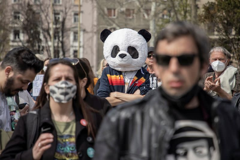 People attend a protest in front of the Serbian parliament in Belgrade