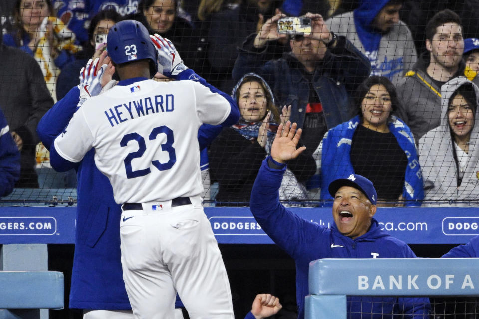 Los Angeles Dodgers' Jason Heyward, left, is congratulated by manager Dave Roberts, right, after hitting a two-run home run during the fifth inning of a baseball game Monday, April 3, 2023, in Los Angeles. (AP Photo/Mark J. Terrill)