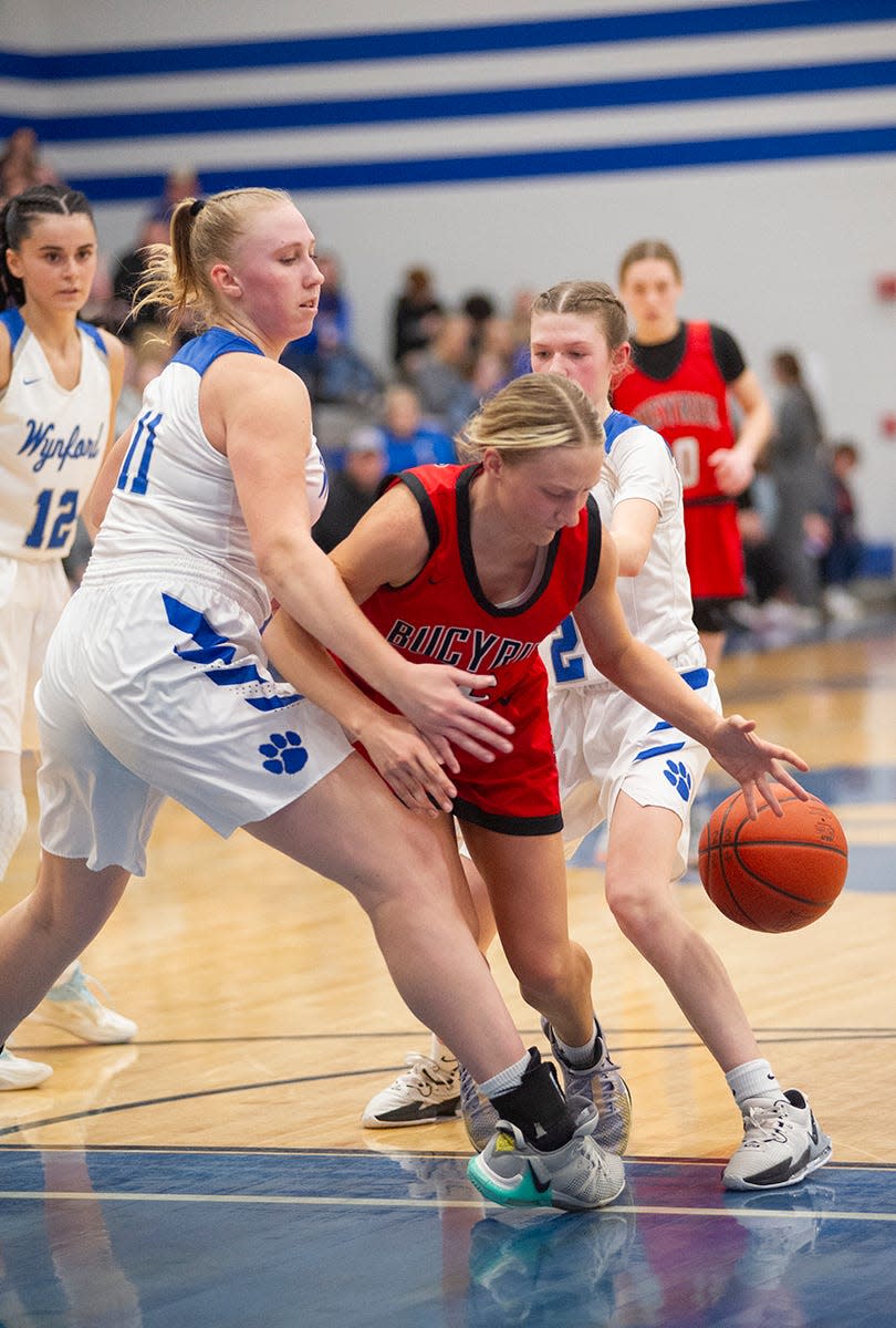 Bucyrus' Marissa Middleton slips past Wynford's Brooke Frombaugh toward the basket.