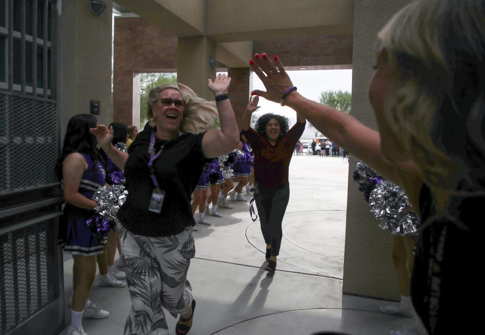 Some of the school staff gets fired up for the first day of school in Indio, Calif., August 15, 2023. 