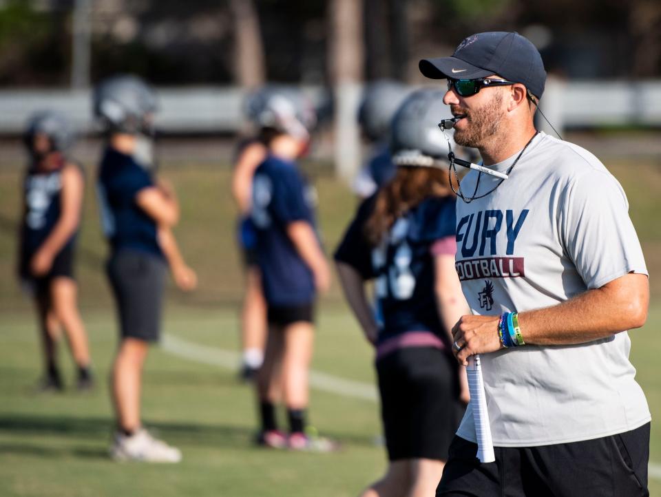 Fountain Inn head football coach Brett Nichols runs  drills with his team, at Fountain Inn High School, Friday, July 29, 2022. 