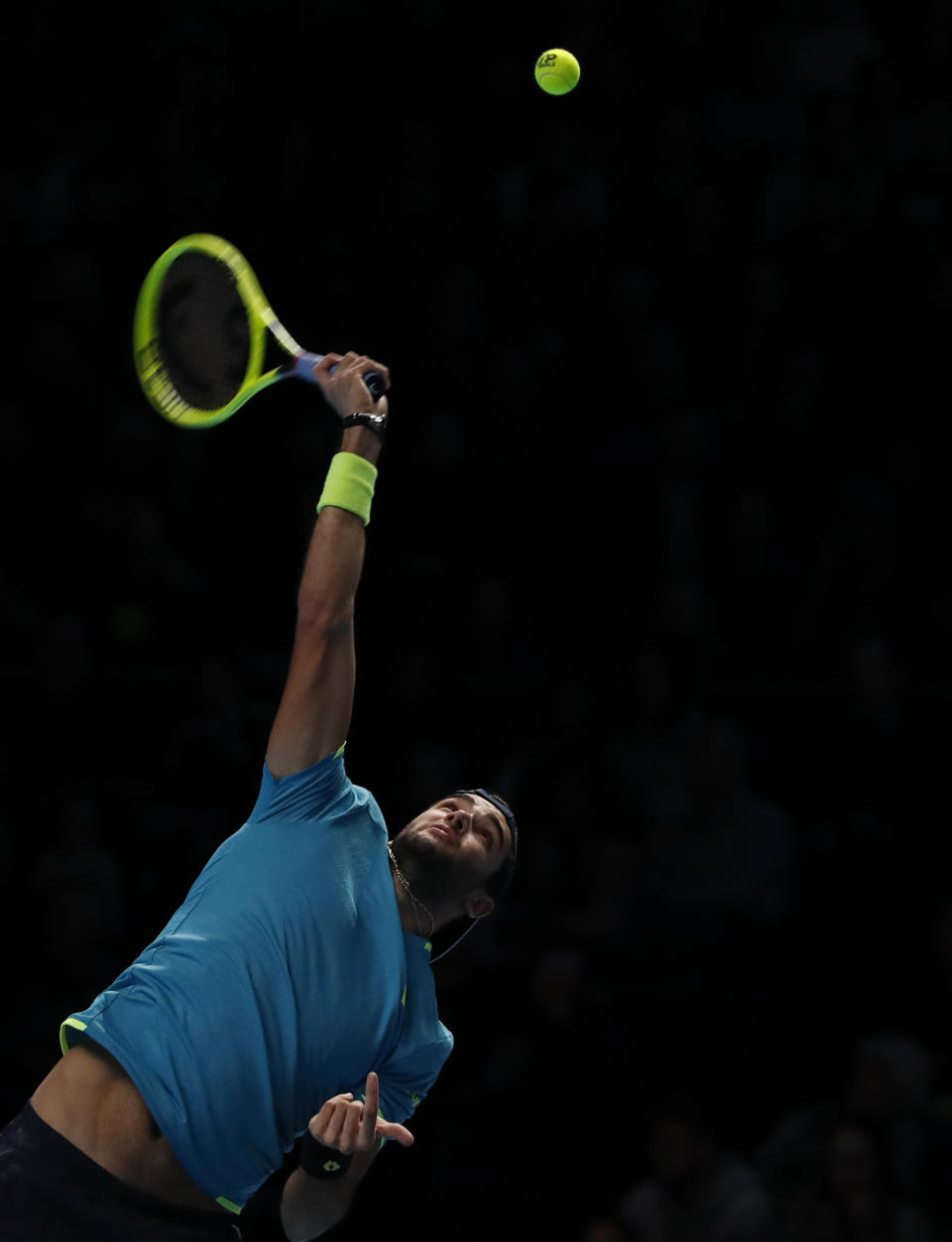 Italy's Matteo Berrettini serves to Serbia's Novak Djokovic during their ATP World Tour Finals singles tennis match at the O2 Arena in London, Sunday, Nov. 10, 2019. (AP Photo/Alastair Grant)