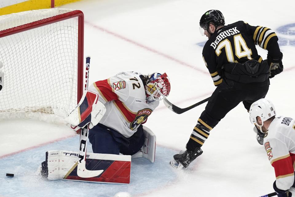 The shot by Boston Bruins' Jake DeBrusk (74) goes between the legs of Florida Panthers' Sergei Bobrovsky (72) but misses the net during the second period in Game 4 of an NHL hockey Stanley Cup second-round playoff series, Sunday, May 12, 2024, in Boston. (AP Photo/Michael Dwyer)