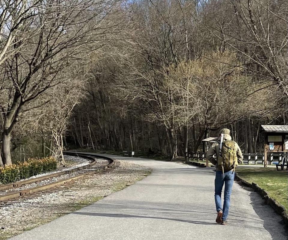 On his way to York, the author strides along the York County Heritage Rail Trail. In his visit, he enjoyed conversation at York Mayor Michael Helfrich’s fire pit, took in Ophelia Chambliss’ art exhibit featuring people who help shape community, toured the restoration of historically Black Lebanon Cemetery with Samantha Dorm and squatted on an outcrop in the Susquehanna River with Paul Nevin to view early Native American rock carvings, called petroglyphs.