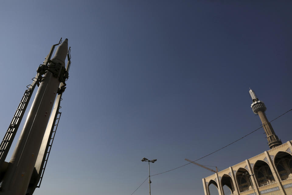 Qiam missile is displayed in front of a minaret of Imam Khomeini grand mosque, in a missile capabilities exhibition by the paramilitary Revolutionary Guard a day prior to second anniversary of Iran's missile strike on U.S. bases in Iraq in Baghdad, at Imam Khomeini grand mosque, in Tehran, Iran, Friday, Jan. 7, 2022. Iran put three ballistic missiles on display on Friday, as talks in Vienna aimed at reviving Tehran's nuclear deal with world powers flounder. (AP Photo/Vahid Salemi)