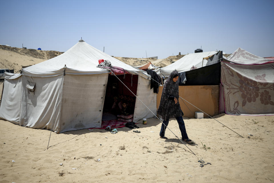 Ola Nassar, 41, who was displaced by the Israeli bombardment of the Gaza Strip, is seen at a makeshift tent camp in Khan Younis, southern Gaza Strip, Thursday, July 4, 2024. Over nine months of war between Israel and Hamas, Palestinian families in Gaza have been uprooted repeatedly, driven back and forth across the territory to escape the fighting. Each time has meant a wrenching move to a new location and a series of crowded, temporary shelters. (AP Photo/Abdel Kareem Hana)