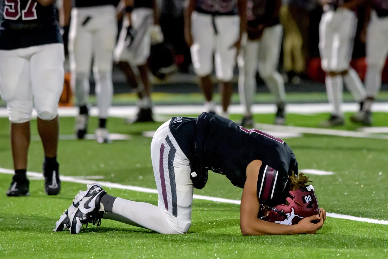 Peoria High quarterback Tino Gist falls to the turf in dejection after the Lions suffered a 40-16 loss to Joliet Catholic in the first round of the Class 5A state football playoffs Friday, Oct. 27, 2023 at Peoria Stadium.