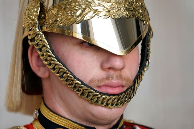 Sweat runs down the face of a member of the Household Troop at Horse Guards Parade in central London, Monday. (Photo: via Associated Press)