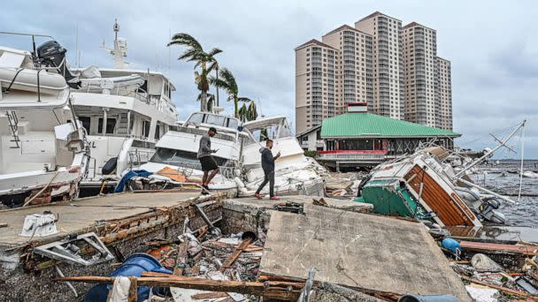 PHOTO: Residents inspect damage to a marina as boats are partially submerged in the aftermath of Hurricane Ian in Fort Myers, Fla., on Sept. 29, 2022. (Giorgio Viera/AFP via Getty Images)