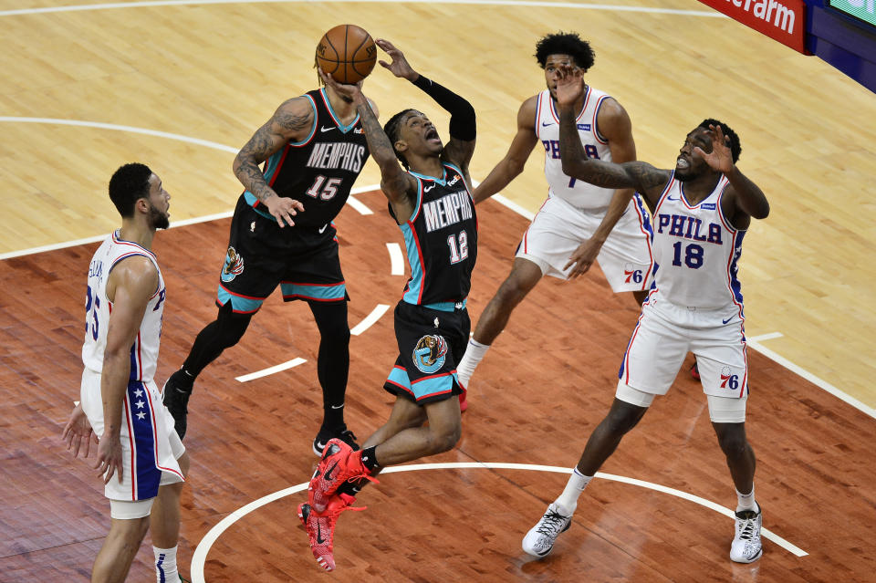 Memphis Grizzlies guard Ja Morant (12) goes to the basket next to Philadelphia 76ers guard Shake Milton (18) during the first half of an NBA basketball game Saturday, Jan. 16, 2021, in Memphis, Tenn. (AP Photo/Brandon Dill)