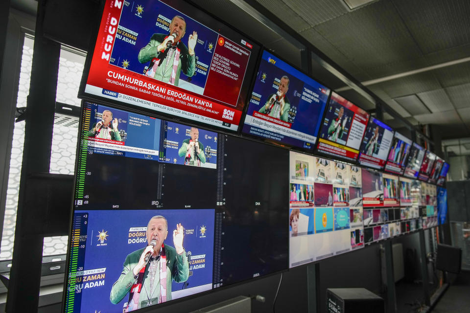 Screens, placed in Turkish Halk TV news channel headquarters, display Turkish President and People's Alliance's presidential candidate Recep Tayyip Erdogan speaking during a rally, in Istanbul, Turkey, Friday, May 5, 2023. (AP Photo/Emrah Gurel)