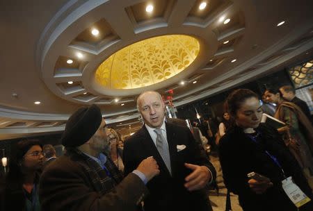 French Foreign Minister Laurent Fabius (C) speaks to the media after attending the 15th Delhi Sustainable Development Summit organised by The Energy and Resources Institute (TERI) in New Delhi February 5, 2015. REUTERS/Adnan Abidi