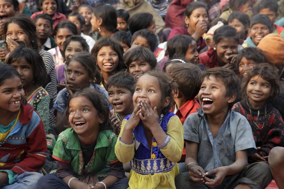 In this Tuesday, Jan. 17, 2017 photo, impoverished Indian children watch a performance as part of advocacy against child labor in Allahabad, India. Despite the country's rapid economic growth, child labor remains widespread in India, where an estimated 13 million children work, with laws meant to keep kids in school and out of the workplace routinely flouted. (AP Photo/Rajesh Kumar Singh, File)