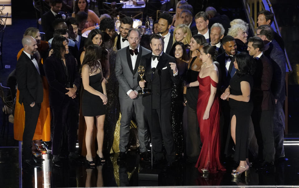 Jason Sudeikis, center, and the cast and crew of "Ted Lasso" accept the Emmy for outstanding comedy series at the 74th Primetime Emmy Awards on Monday, Sept. 12, 2022, at the Microsoft Theater in Los Angeles. (AP Photo/Mark Terrill)