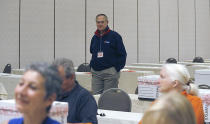 Republican Party Chairman Rich Anderson walks through the room as tellers prepare to begin counting ballots for Virginia's Republican gubernatorial nominee race inside a ballroom at the Marriott Hotel in Richmond, Va., Monday, May 10, 2021. (Bob Brown/Richmond Times-Dispatch via AP)