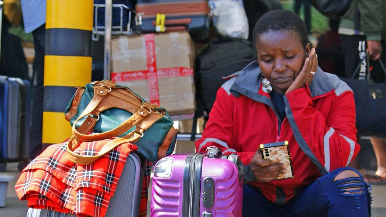 Passengers wait at a closed door at the departures of the Jomo Kenyatta International Airport (JKIA) in Nairobi 