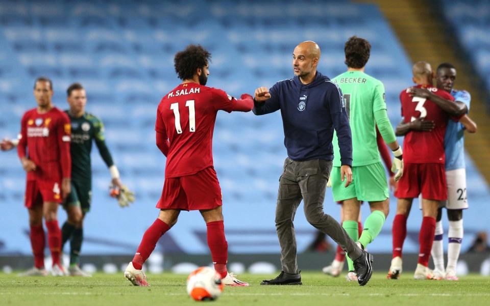  Mohamed Salah of Liverpool interacts with Pep Guardiola, Manager of Manchester City  - GETTY IMAGES