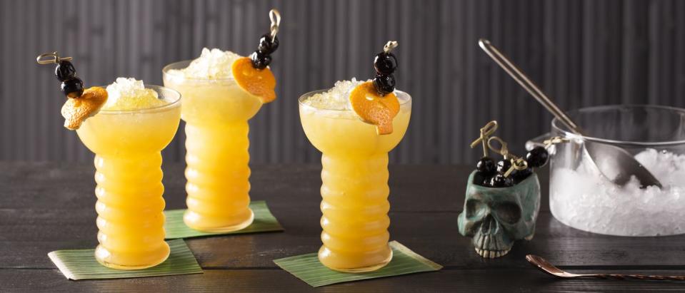 <p><strong>Ingredients</strong></p><p>.75 cup Cruzan Aged Light Rum<br>.75 cup Cruzan Aged Dark Rum<br>.75 cup apricot liqueur<br>2.25 cups orange juice<br>6 dashes lime bitters<br>.75 cup Cruzan Black Strap Rum<br>Orange peel and cherries for garnish</p><p><strong>Instructions</strong></p><p>Combine light rum, dark rum, apricot liqueur, orange juice and lime bitters in an ice filled pitcher or punch bowl and mix well. Pour equal parts into six tall glasses filled with ice. Float one part black strap rum on top of each glass, then garnish with the orange peel and a cocktail pick of cherries.</p><p><em>For Skeleton Garnish:</em> Peel orange rind and lay flat on surface. Take circle cookie cutter and cut circle space out of the peel. Use paring knife to cut mini circles for eyes, nose, and jaw of skeleton garnish</p>