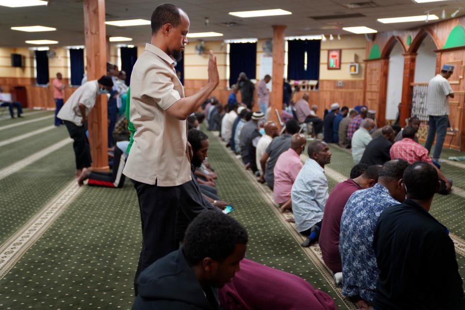 Yusuf Abdulle, standing, director of the Islamic Association of North America, prays with fellow Muslims at the Abubakar As-Saddique Islamic Center in Minneapolis on May 12, 2022.