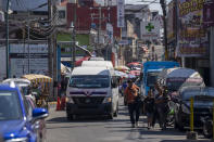 A passenger van starts its route from a station in Tapachula, Mexico, Thursday, Jan. 19, 2023. With threatening phone calls, burned minibuses and at least three suspected killings, street gangs more closely associated with Central America are imposing their brand of terror-based extortion on transport drivers in southern Mexico. (AP Photo/Moises Castillo)