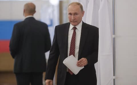 Vladimir Putin casts his ballot on Sunday at a polling place at the Russian Academy of Sciences - Credit: &nbsp;Mikhail Metzel/TASS via Getty