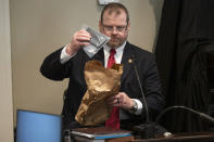 Britt Dove, SLED agent specialist in computer forensics, returns a cell phone to an evidence bag during Alex Murdaugh's trial for murder at the Colleton County Courthouse in Walterboro, S.C., on Wednesday, Feb. 1, 2023. (Joshua Boucher/The State via AP, Pool)