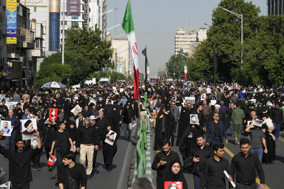 Iranians attend a funeral ceremony for the late President Ebrahim Raisi and his companions who were killed in a helicopter crash on Sunday in a mountainous region of the country's northwest, in Tehran, Iran, Wednesday, May 22, 2024. Iran's supreme leader presided over the funeral Wednesday for the country's late president, foreign minister and others killed in the helicopter crash, as tens of thousands later followed a procession of their caskets through the capital, Tehran. (AP Photo/Vahid Salemi)