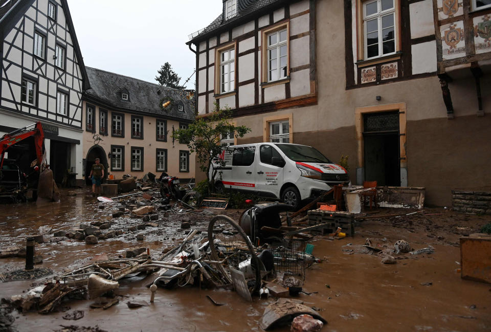 Image: A damaged car and bicycles are pictured in a muddy street in Ahrweiler-Bad Neuenahr, western Germany, (Christof Stache / AFP - Getty Images)