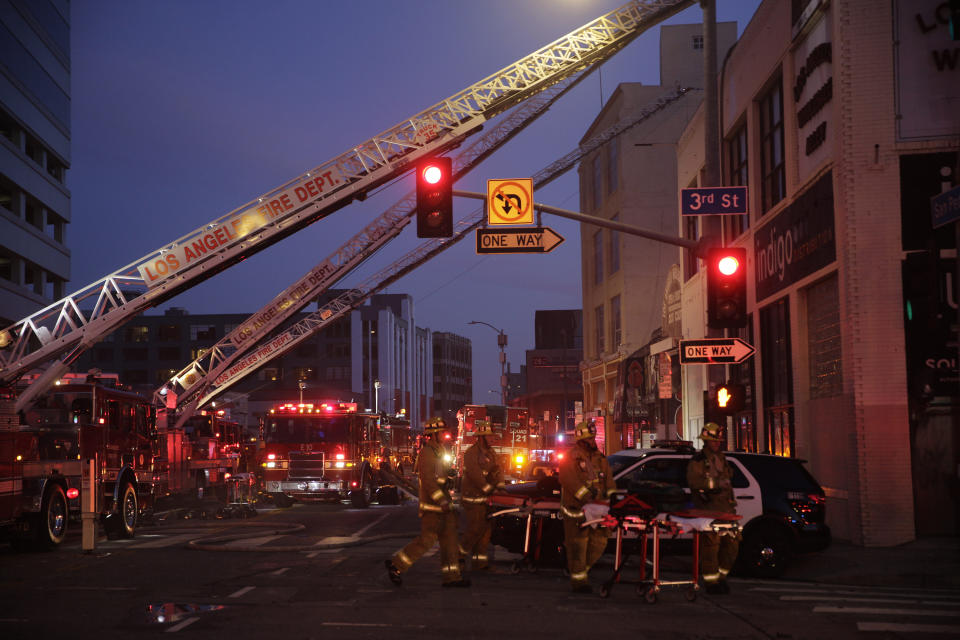 Los Angeles Fire Department firefighters work the scene of a structure fire that injured multiple firefighters, according to a fire department spokesman, Saturday, May 16, 2020, in Los Angeles. (AP Photo/Damian Dovarganes)