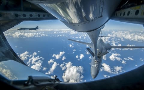 An Air Force B-1B Lancer receives fuel from a KC-135 Stratotanker near the East China Sea - Credit: AFP