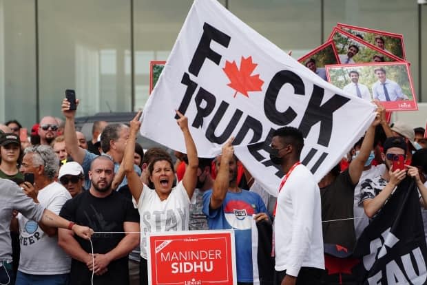 Protesters wait for Liberal Leader Justin Trudeau to arrive at a campaign event in Bolton, Ont., on Friday that was later cancelled over security concerns. (Sean Kilpatrick/The Canadian Press - image credit)