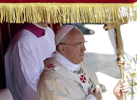 Pope Francis holds his pastoral cross as he leads the Easter mass in Saint Peter's Square at the Vatican April 20, 2014. REUTERS/Tony Gentile