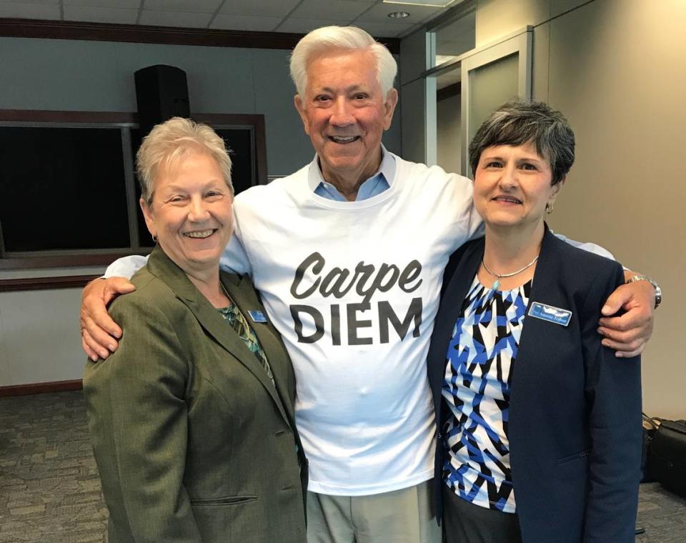 Colleagues Cecile Holt, left, and Annette Trahan visit with George Schoegel at a bank meeting. Both women are legacy employees of Whitney Bank and are now retired.