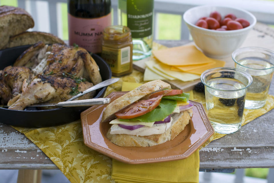 This April 30, 2012 photo, shows a roasted chicken, a bottle of wine and sandwich for a romantic picnic in Concord, N.H. (AP Photo/Matthew Mead)