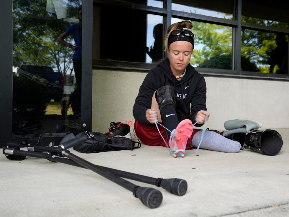 Katie Bondy puts on a soccer cleat at Hanger Clinic during her last prosthetic and orthotic fitting appointment before the Amp Futbol Cup in Warsaw, Poland.