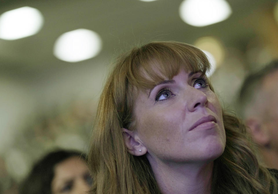 FILE - Labour deputy leader Angela Rayner watches as the leader of the British Labour Party Keir Starmer makes his keynote speech at the annual party conference in Brighton, England, Wednesday, Sept. 29, 2021. Women from across British politics called Monday, April 25, 2022 for action to tackle misogyny after a newspaper ran a story accusing the deputy opposition leader of trying to “distract” the prime minister during debates by crossing and uncrossing her legs. (AP Photo/Alastair Grant, File)