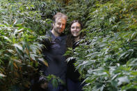Chip and Jessica Baker pose for a photo at their marijuana nursery at Baker's Medical, Wednesday, Feb. 26, 2020, in Oklahoma City. When voters in conservative Oklahoma approved medical marijuana in 2018, many thought the rollout would be ploddingly slow and burdened with bureaucracy. Instead, business is booming so much cannabis industry workers and entrepreneurs are moving to Oklahoma from states with more well-established pot cultures, like California, Colorado and Oregon. (AP Photo/Sue Ogrocki)