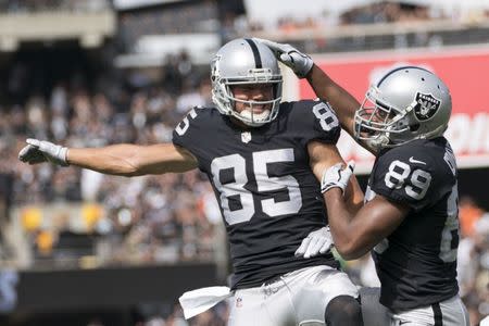 FILE PHOTO - September 30, 2018; Oakland, CA, USA; Oakland Raiders wide receiver Amari Cooper (89) is congratulated by tight end Derek Carrier (85) for scoring a touchdown against the Cleveland Browns during the second quarter at Oakland Coliseum. Mandatory Credit: Kyle Terada-USA TODAY Sports