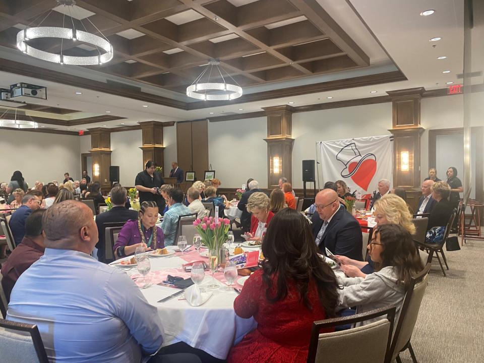 Attendees listen to emcee Patrick Evans at the Women of Wonder Luncheon at The Classic Club on April 29, 2022.