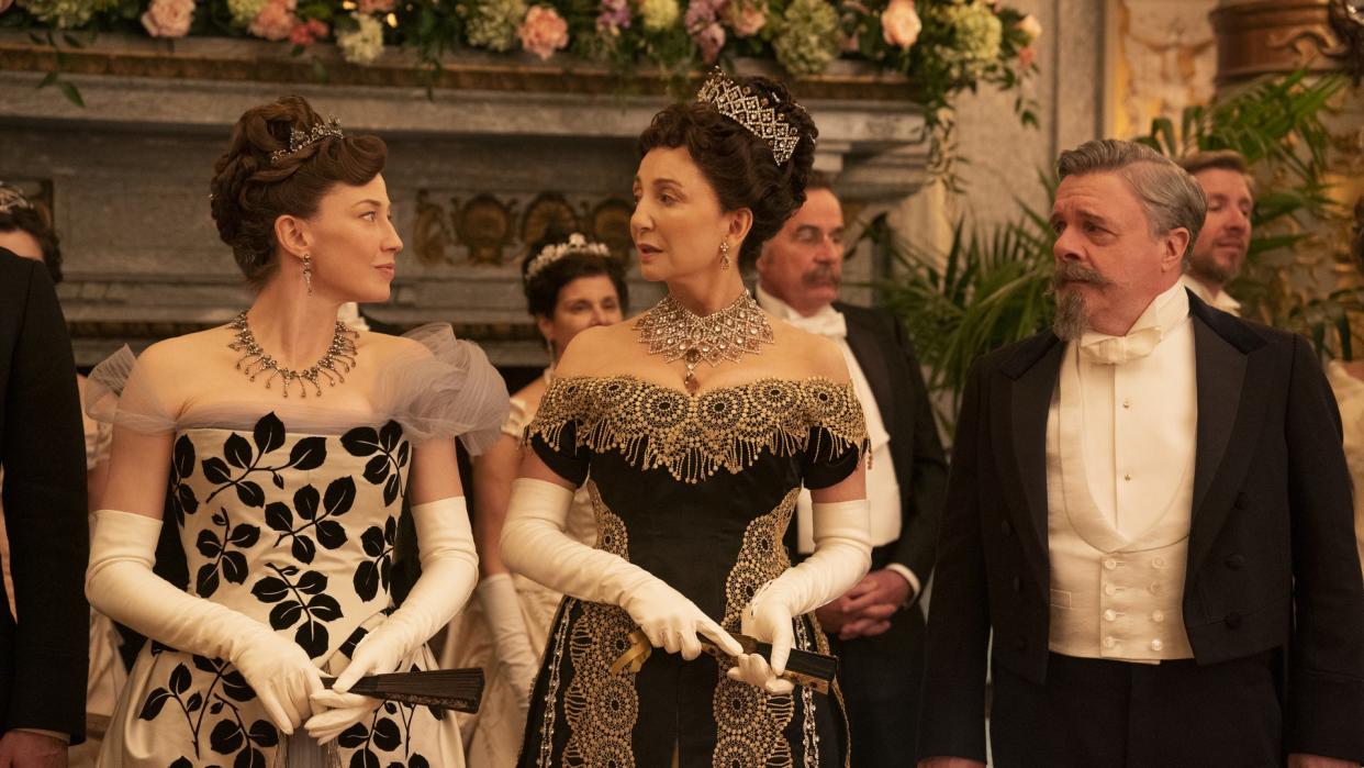  10 best The Gilded Age costumes. Pictured: Carrie Coon stares at Donna Murphy with Nathan Lane standing next to them in The Gilded Age. 