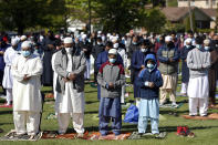 Muslims perform an Eid al-Fitr prayer in an outdoor open area, marking the end of the fasting month of Ramadan, Thursday, May 13, 2021 in Morton Grove, Ill. (AP Photo/Shafkat Anowar)