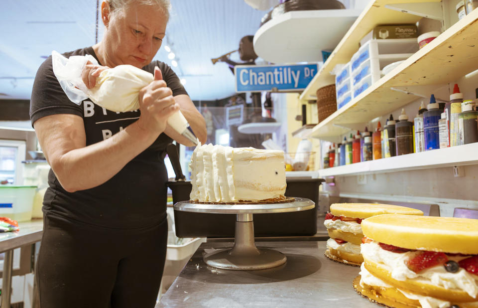 Chaya Conrad, owner of Bywater Bakery in New Orleans, works on a Berry Chantilly Cake (C. Ross / Getty Images)