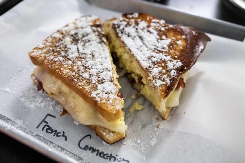 The $11 “French Connection” grilled cheese sandwich from at Shift Coffee House, ready to serve on Wednesday, May 29, 2024, features mozzarella eggs, bacon, maple syrup, cinnamon sugar and powdered sugar on French bread.