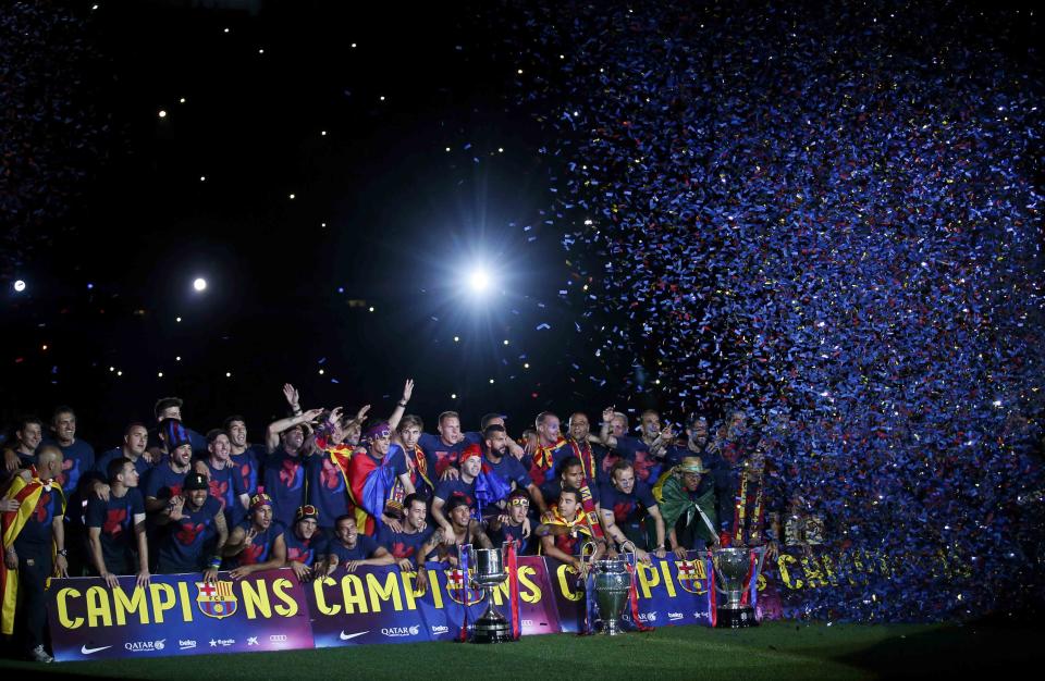 Barcelona's players and staff members pose with their trophies during celebration parade at Camp Nou stadium in Barcelona, Spain, June 7, 2015. Barcelona were crowned kings of Europe for the fifth time after beating Juventus 3-1 in a pulsating Champions League final at the Olympic Stadium on Saturday, capping their magnificent season with a title treble.         REUTERS/Albert Gea