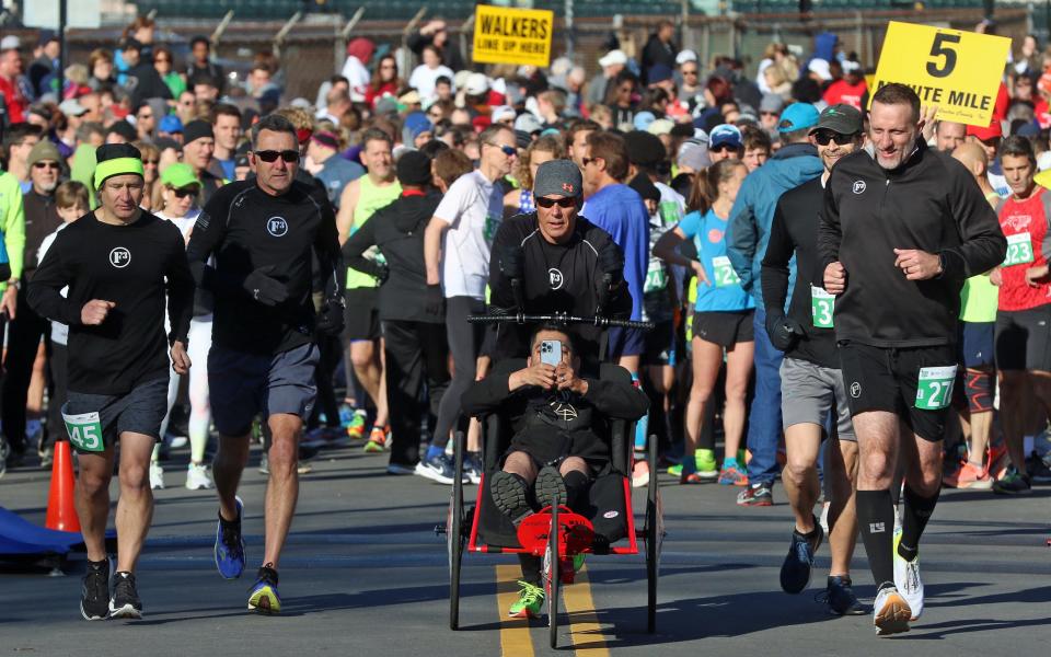 Members of the Speed for Need team begin prior to the start of the Gaston Community Foundation 5K Run early Saturday morning, April 9, 2022.