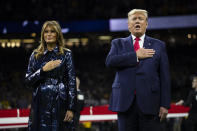 President Donald Trump and first lady Melania Trump stand for the national anthem before the beginning of the College Football Playoff National Championship game between LSU and Clemson, Monday, Jan. 13, 2020, in New Orleans. (AP Photo/ Evan Vucci)
