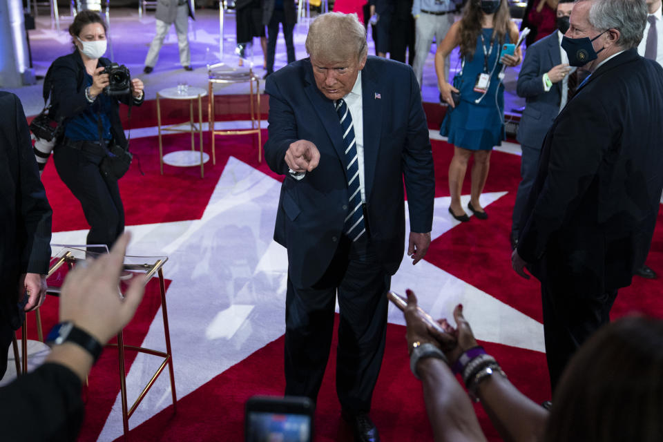 President Donald Trump talks with voters after an NBC News Town Hall, at Perez Art Museum Miami, Thursday, Oct. 15, 2020, in Miami. (AP Photo/Evan Vucci)