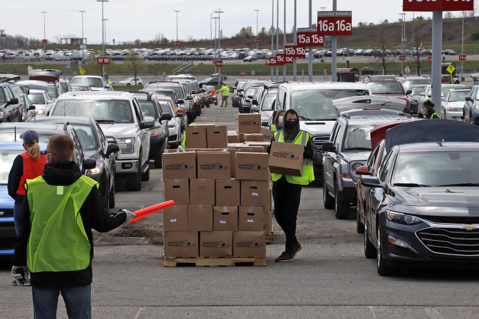 Keystone State residents fill an empty Pittsburgh International Airport parking lot during a drive-up food distribution. (AP Photo/Gene J. Puskar)